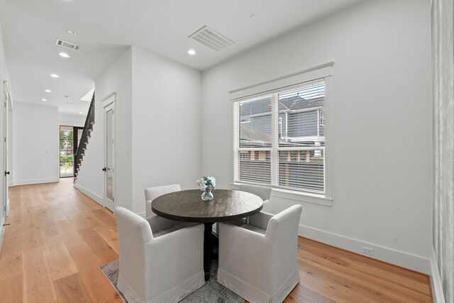 1313 Waverly St, Houston, TX 77008 - dining space with light wood-style flooring, stairs, and recessed lighting