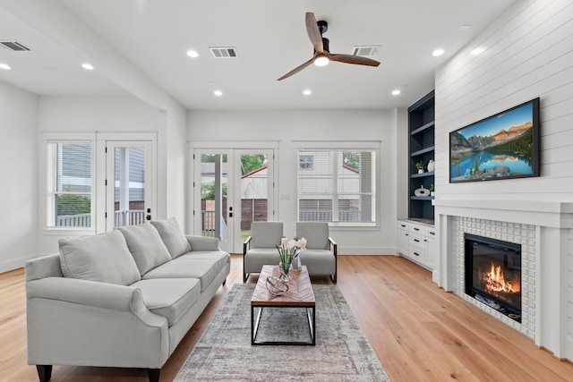 1313 Waverly St, Houston, TX 77008 - living room with light wood finished floors, built in features, a ceiling fan, recessed lighting, and a tiled fireplace