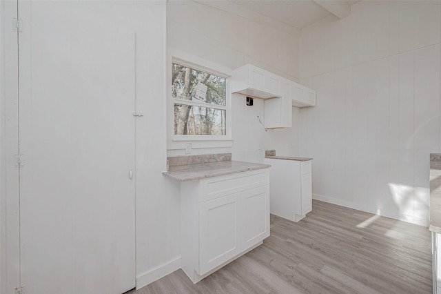 492 Trinity Rd, Dayton, TX 77535 - kitchen with light wood-type flooring, white cabinets, and beamed ceiling