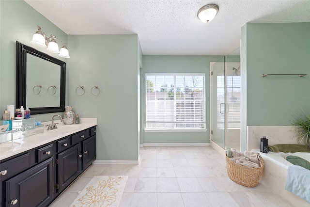 11303 Golden Ray Dr, Cypress, TX 77429 - bathroom with double vanity, a shower stall, a garden tub, a textured ceiling, and tile patterned floors