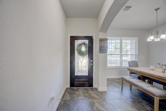 3502 Singing Flower Ln, Richmond, TX 77406 - entryway with arched walkways, a chandelier, and a textured wall