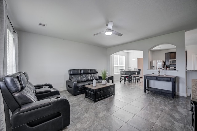 3502 Singing Flower Ln, Richmond, TX 77406 - living area featuring arched walkways, ceiling fan, and tile patterned flooring