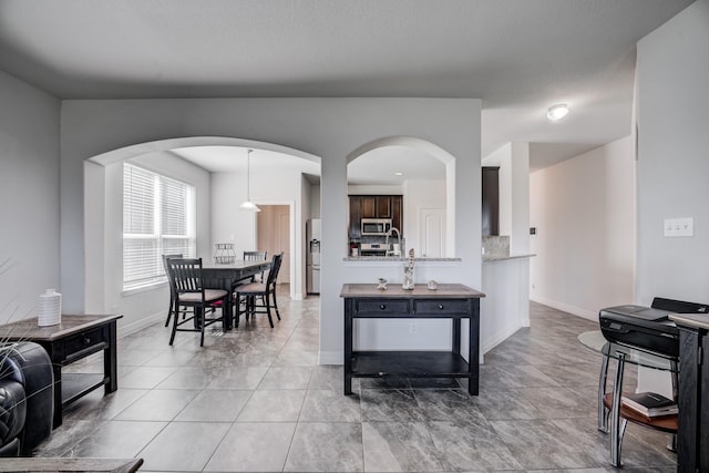 3502 Singing Flower Ln, Richmond, TX 77406 - living area featuring light tile patterned floors and arched walkways