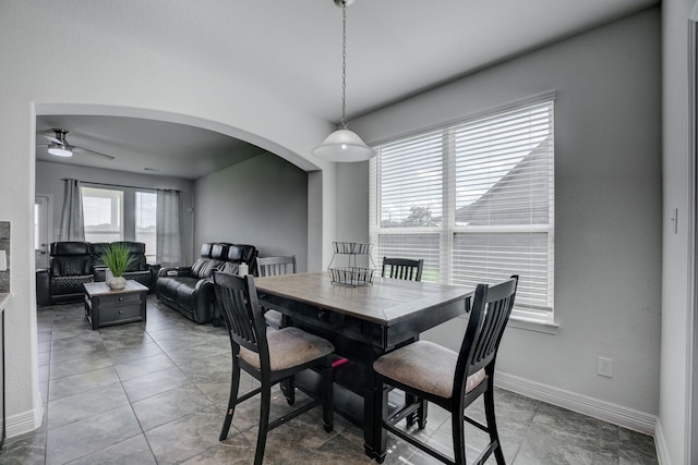 3502 Singing Flower Ln, Richmond, TX 77406 - dining room featuring arched walkways, ceiling fan, and tile patterned flooring
