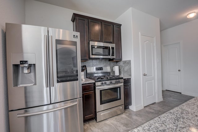 3502 Singing Flower Ln, Richmond, TX 77406 - kitchen featuring stainless steel appliances, dark brown cabinetry, light stone countertops, and tasteful backsplash