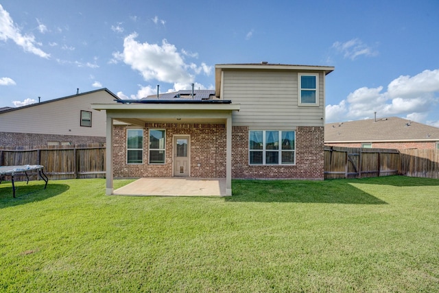 3502 Singing Flower Ln, Richmond, TX 77406 - back of house with a patio area, brick siding, a fenced backyard, and solar panels