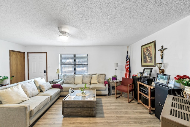 5673 Fm 1094th Rd, Sealy, TX 77474 - living room featuring light wood finished floors, a ceiling fan, and a textured ceiling
