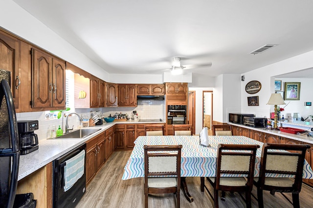 5673 Fm 1094th Rd, Sealy, TX 77474 - kitchen featuring light wood-style flooring, ceiling fan, decorative backsplash, and light countertops