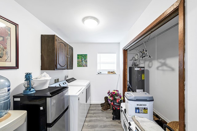 5673 Fm 1094th Rd, Sealy, TX 77474 - washroom featuring water heater, cabinet space, independent washer and dryer, and light wood-style flooring