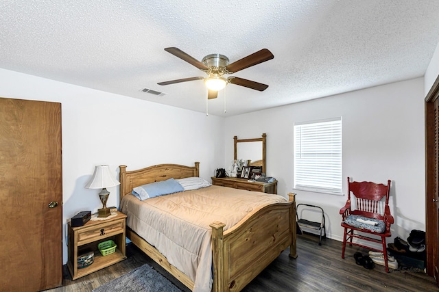 5673 Fm 1094th Rd, Sealy, TX 77474 - bedroom with wood finished floors, ceiling fan, and a textured ceiling