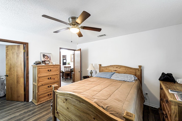5673 Fm 1094th Rd, Sealy, TX 77474 - bedroom featuring wood finished floors, a textured ceiling, and a ceiling fan