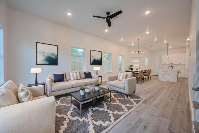 6749 Liverpool St, Houston, TX 77021 - living room with ceiling fan, a chandelier, light wood-style floors, and recessed lighting