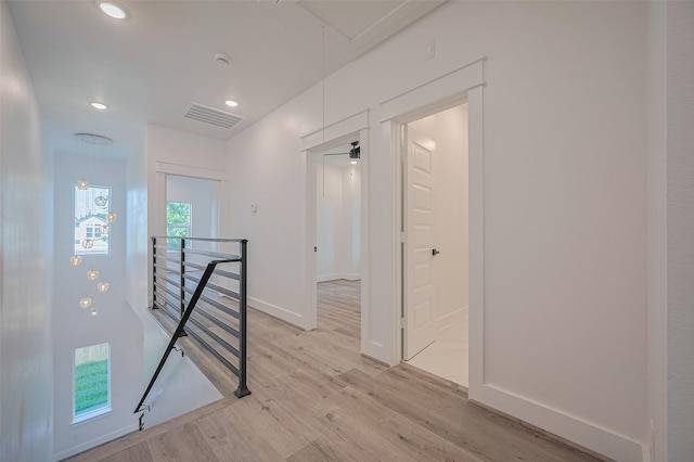 6749 Liverpool St, Houston, TX 77021 - corridor with an upstairs landing, attic access, light wood finished floors, and recessed lighting