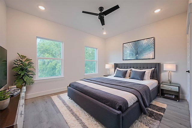 6749 Liverpool St, Houston, TX 77021 - bedroom featuring multiple windows, light wood-type flooring, a ceiling fan, and recessed lighting