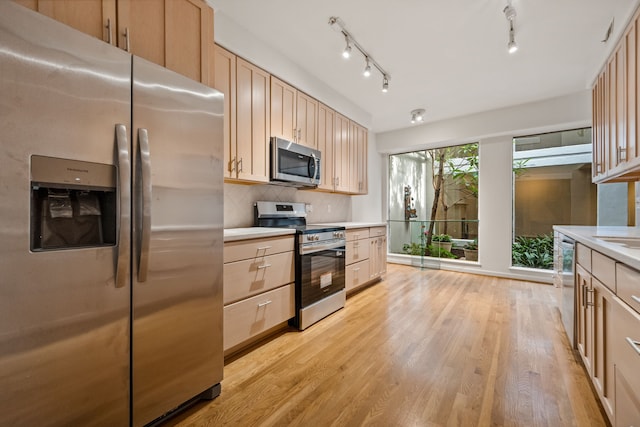 1016 Barkdull St, Houston, TX 77006 - kitchen with stainless steel appliances, light brown cabinets, light countertops, and light wood-type flooring
