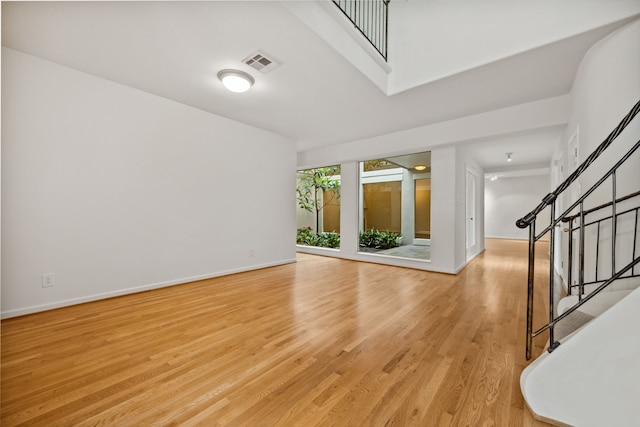 1016 Barkdull St, Houston, TX 77006 - empty room with light wood-style floors and stairway