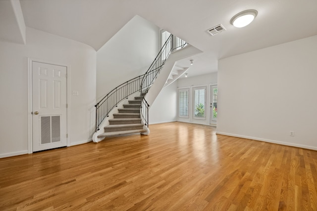 1016 Barkdull St, Houston, TX 77006 - unfurnished living room featuring stairs and light wood finished floors