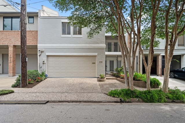 1016 Barkdull St, Houston, TX 77006 - view of property featuring concrete driveway, a garage, and stucco siding