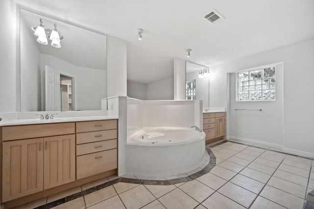 1016 Barkdull St, Houston, TX 77006 - full bathroom featuring two vanities, a jetted tub, tile patterned flooring, and inlaid floor details