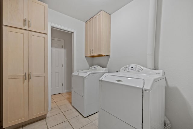 1016 Barkdull St, Houston, TX 77006 - laundry room with independent washer and dryer, cabinet space, and light tile patterned flooring