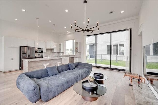 9805 Finch Falls Ln, Houston, TX 77080 - living area with a chandelier, light wood-type flooring, and recessed lighting