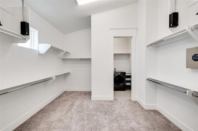 9805 Finch Falls Ln, Houston, TX 77080 - walk in closet with light carpet and washer / dryer