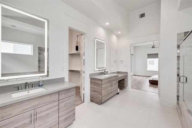 9805 Finch Falls Ln, Houston, TX 77080 - bathroom featuring a stall shower, two vanities, recessed lighting, a ceiling fan, and tile patterned flooring