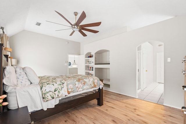12727 Regal Pine Ln, Houston, TX 77070 - bedroom with light wood-type flooring, lofted ceiling, arched walkways, and ceiling fan