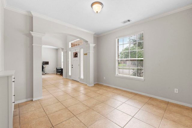 12727 Regal Pine Ln, Houston, TX 77070 - empty room featuring decorative columns, arched walkways, light tile patterned flooring, and crown molding