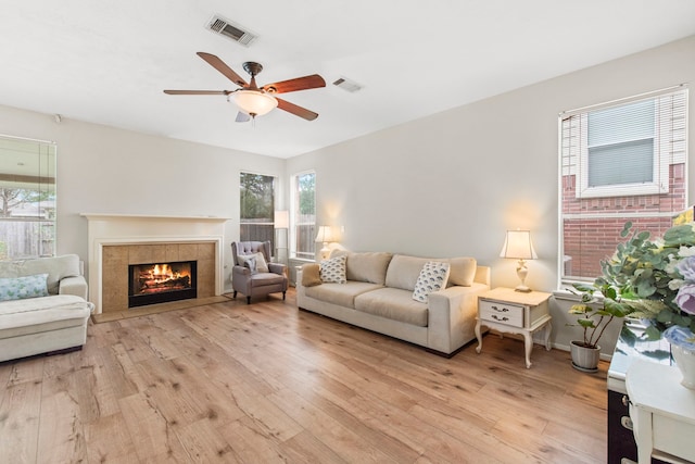 12727 Regal Pine Ln, Houston, TX 77070 - living area featuring light wood-type flooring, ceiling fan, and a fireplace