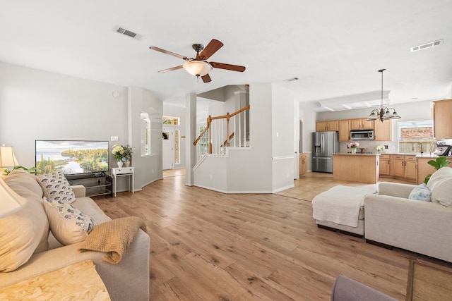 12727 Regal Pine Ln, Houston, TX 77070 - living area featuring light wood-style floors, a ceiling fan, and plenty of natural light