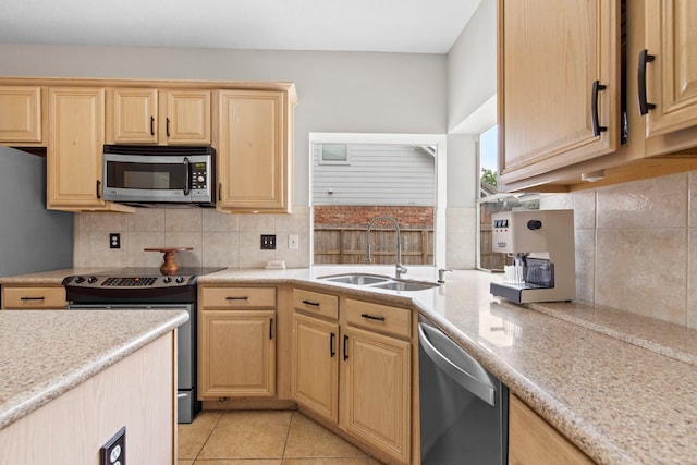 12727 Regal Pine Ln, Houston, TX 77070 - kitchen featuring appliances with stainless steel finishes, light brown cabinetry, and backsplash