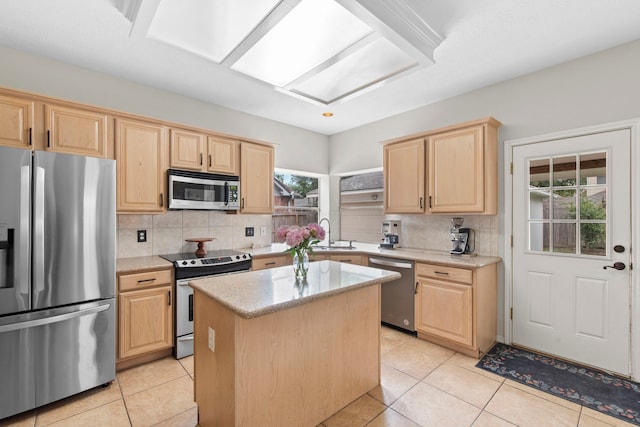 12727 Regal Pine Ln, Houston, TX 77070 - kitchen featuring appliances with stainless steel finishes, light brown cabinetry, decorative backsplash, a kitchen island, and light tile patterned floors
