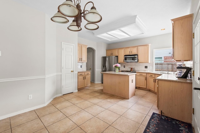 12727 Regal Pine Ln, Houston, TX 77070 - kitchen with stainless steel appliances, light tile patterned floors, a chandelier, arched walkways, and light brown cabinetry