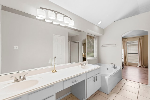 12727 Regal Pine Ln, Houston, TX 77070 - full bathroom featuring tile patterned floors, plenty of natural light, a garden tub, lofted ceiling, and a shower stall