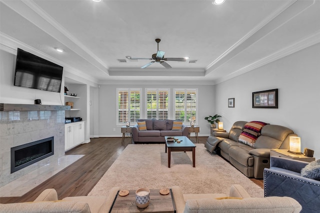 5523 Darschelle Dr, Houston, TX 77069 - living area with dark wood finished floors, a raised ceiling, a tile fireplace, a ceiling fan, and recessed lighting