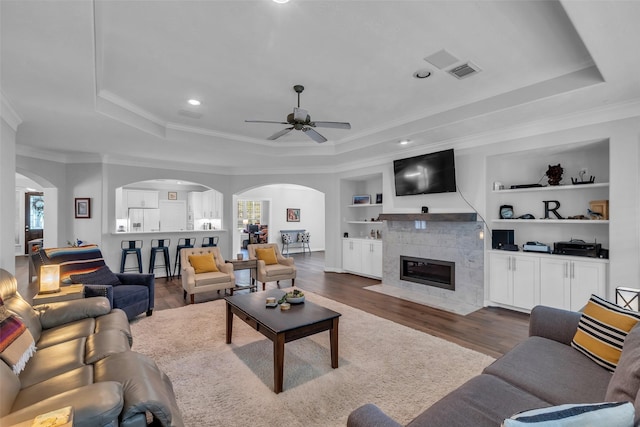 5523 Darschelle Dr, Houston, TX 77069 - living area with a tray ceiling, arched walkways, ceiling fan, ornamental molding, and recessed lighting