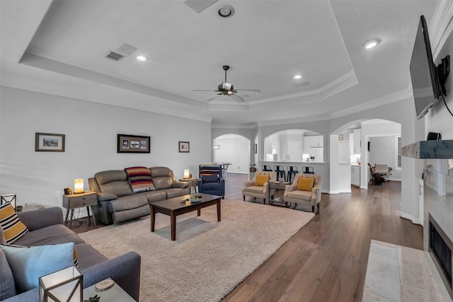 5523 Darschelle Dr, Houston, TX 77069 - living area with a raised ceiling, arched walkways, ceiling fan, hardwood / wood-style floors, and recessed lighting