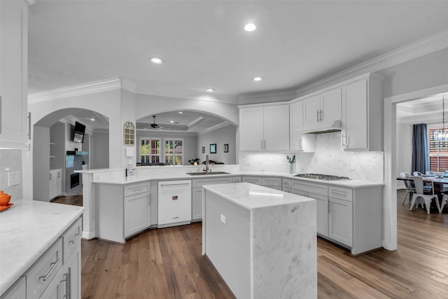 5523 Darschelle Dr, Houston, TX 77069 - kitchen with white dishwasher, stainless steel gas stovetop, recessed lighting, ornamental molding, and a peninsula