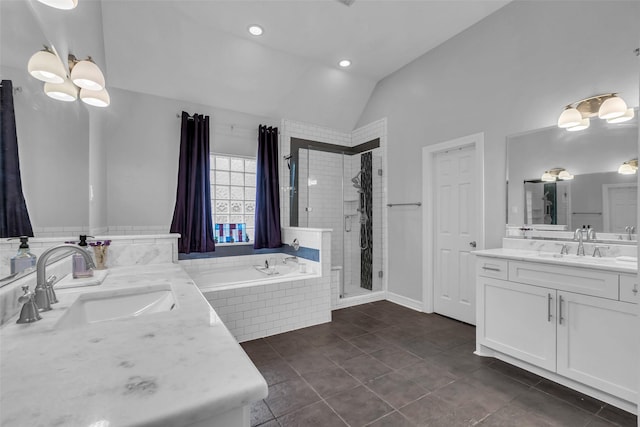 5523 Darschelle Dr, Houston, TX 77069 - bathroom featuring vaulted ceiling, a shower stall, a garden tub, two vanities, and tile patterned floors