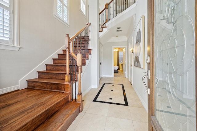 918 Detering St, Houston, TX 77007 - foyer featuring a towering ceiling, stairway, light tile patterned flooring, and inlaid floor details