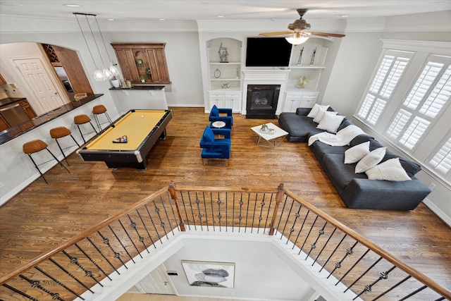 918 Detering St, Houston, TX 77007 - living room with wood finished floors, ceiling fan, a glass covered fireplace, crown molding, and stairway