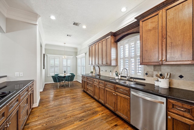 918 Detering St, Houston, TX 77007 - kitchen featuring dishwasher, dark wood-type flooring, ornamental molding, healthy amount of natural light, and brown cabinetry