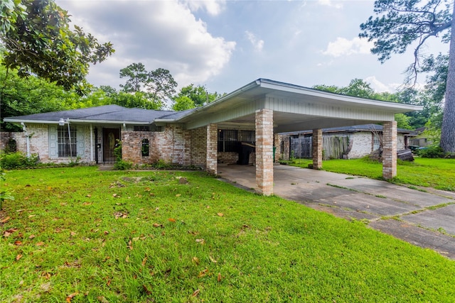 7726 Melanie St, Houston, TX 77016 - view of front facade with a front yard, brick siding, driveway, and an attached carport