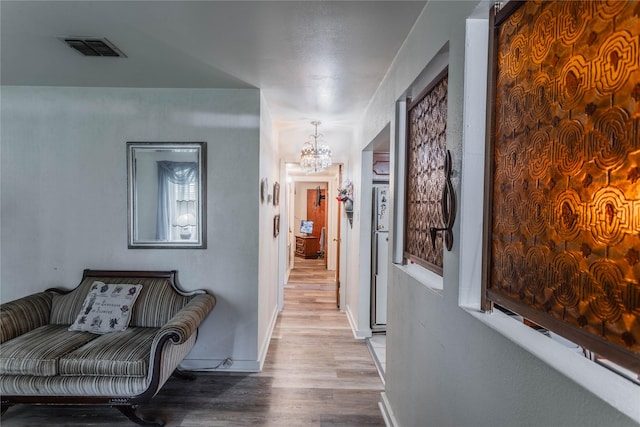 7726 Melanie St, Houston, TX 77016 - corridor with wood finished floors and a chandelier