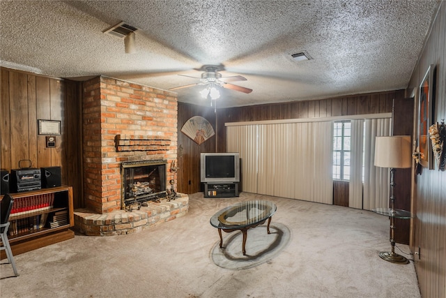7726 Melanie St, Houston, TX 77016 - unfurnished living room with carpet flooring, wood walls, ceiling fan, and a brick fireplace