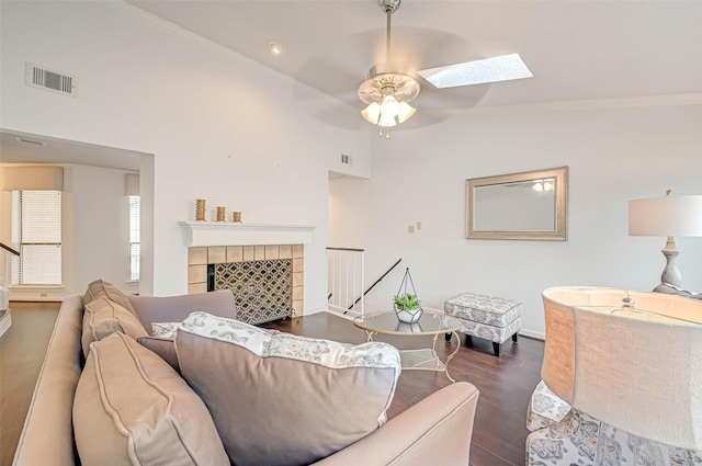 2277 S Kirkwood Rd Unit 906, Houston, TX 77077 - living area with ceiling fan, wood finished floors, a skylight, lofted ceiling, and a tile fireplace