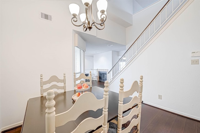 2277 S Kirkwood Rd Unit 906, Houston, TX 77077 - dining room featuring a chandelier, wood finished floors, and a tile fireplace