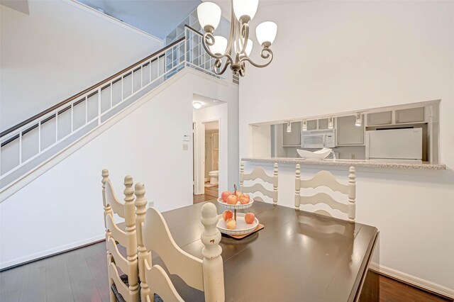 2277 S Kirkwood Rd Unit 906, Houston, TX 77077 - dining room with a chandelier, a high ceiling, dark wood-type flooring, and stairs