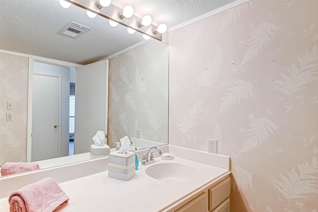 2277 S Kirkwood Rd Unit 906, Houston, TX 77077 - bathroom with a textured ceiling, wallpapered walls, and vanity